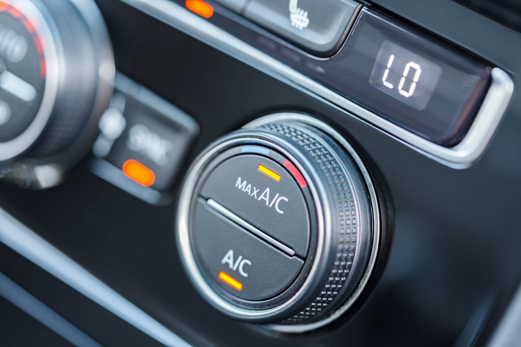 Vehicle air conditioning controls with the A/C and MAX A/C buttons illuminated.